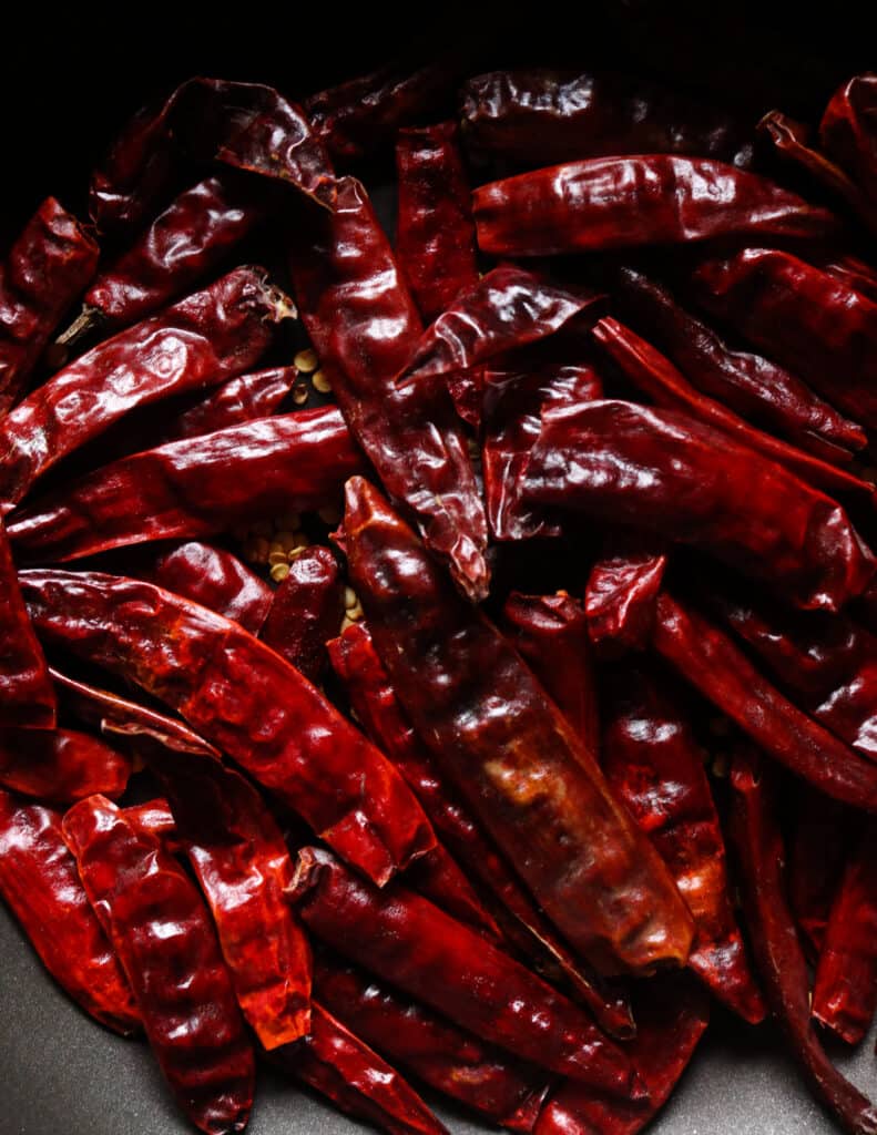 dryy roasting dry red chillies to make the jaffna curry powder.