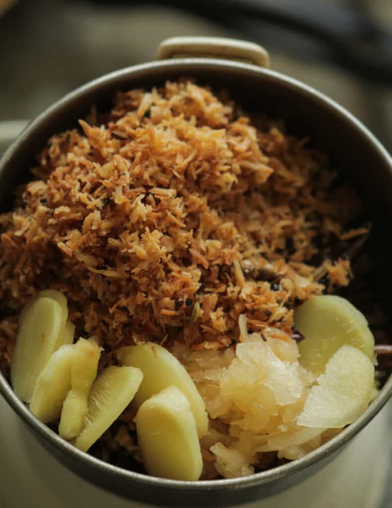 mincing the roasted coconut, ginger and garlic for chettinad chicken
