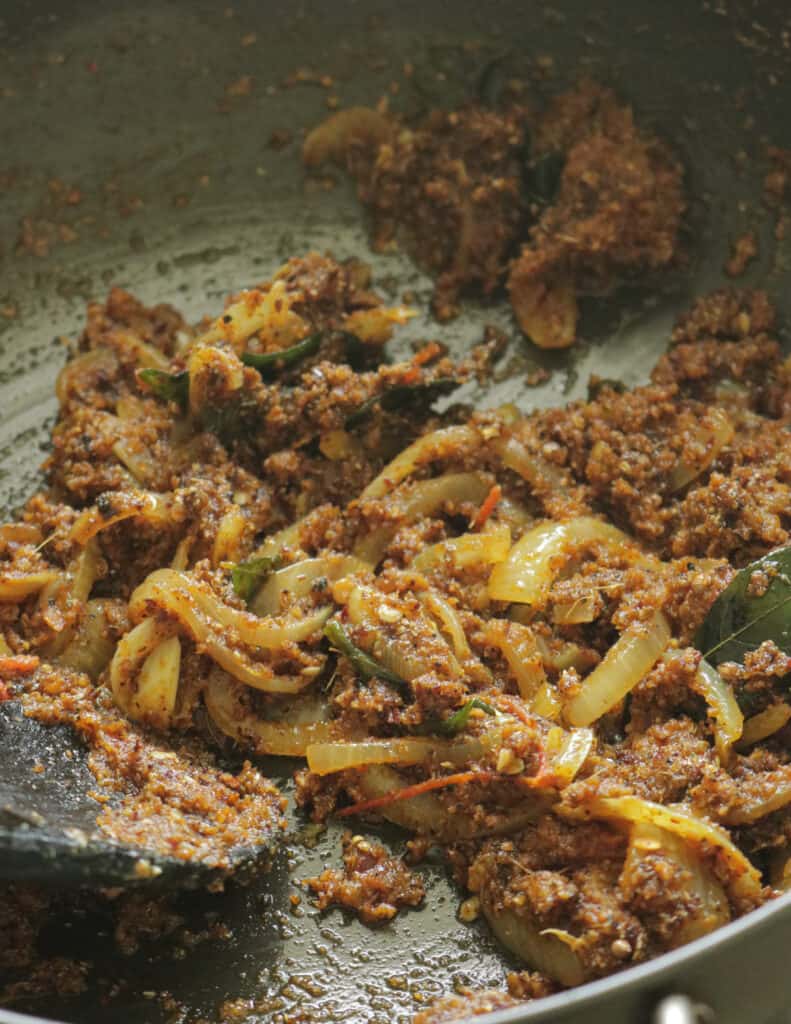 making the spice masala in a pan to cook chettinad chicken.