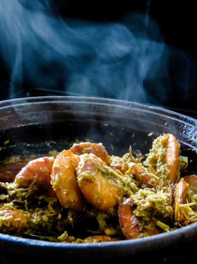  coconut-shrimp curry ina clay pot with aromatic flavors from the spice and coconut.