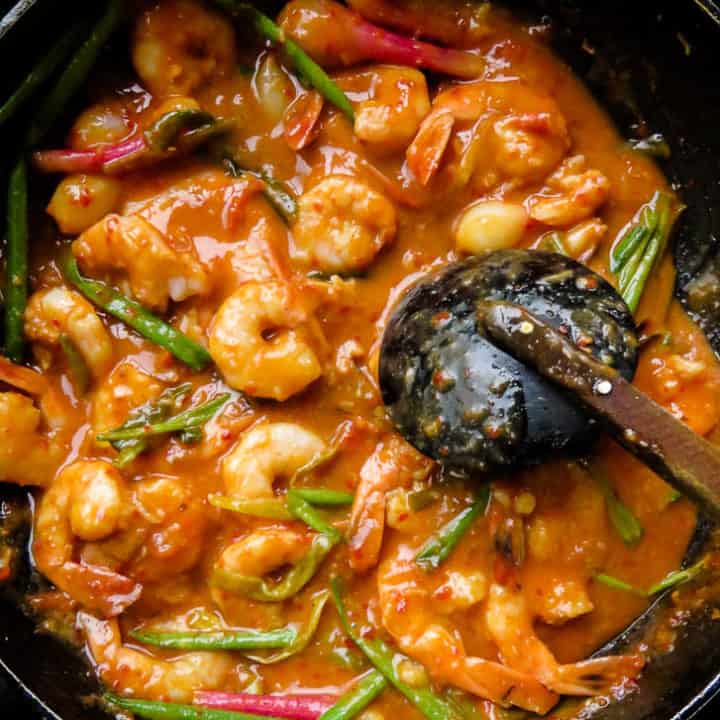 sriracha shrimp with coconut milk sauce cooked in a skillet