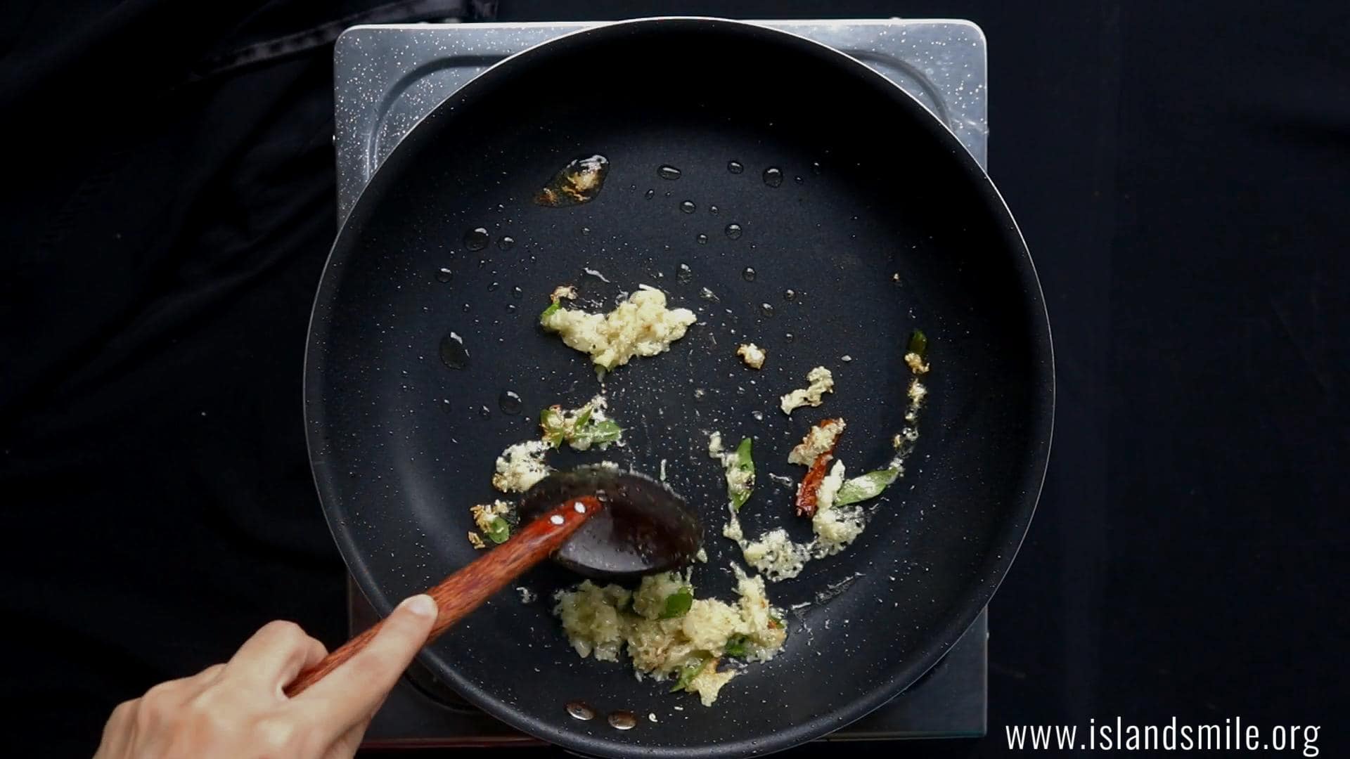 tempering the ginger and minced garlic to cook devilled beef.