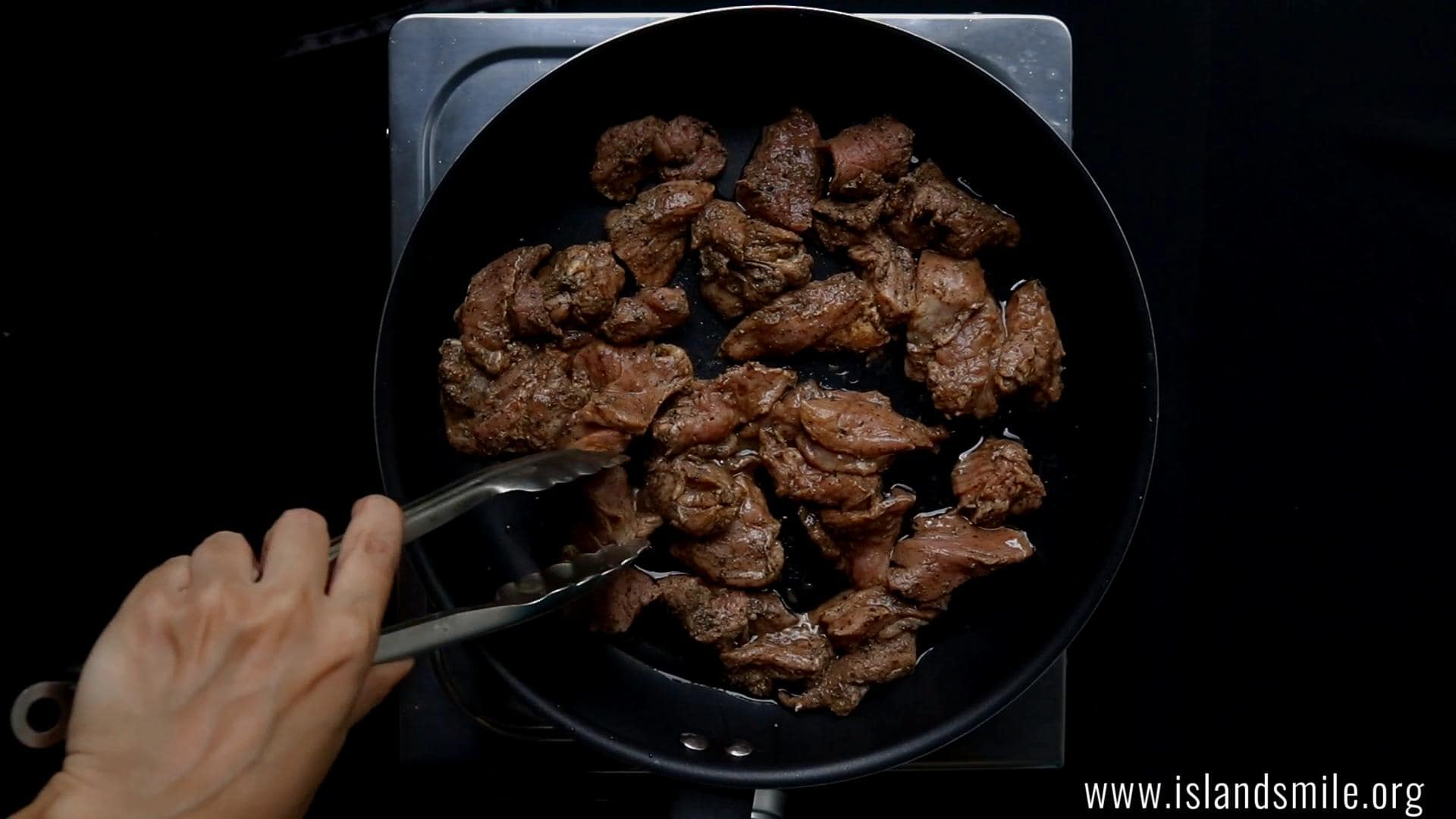 Placing the beef to fry and make devilled beef.