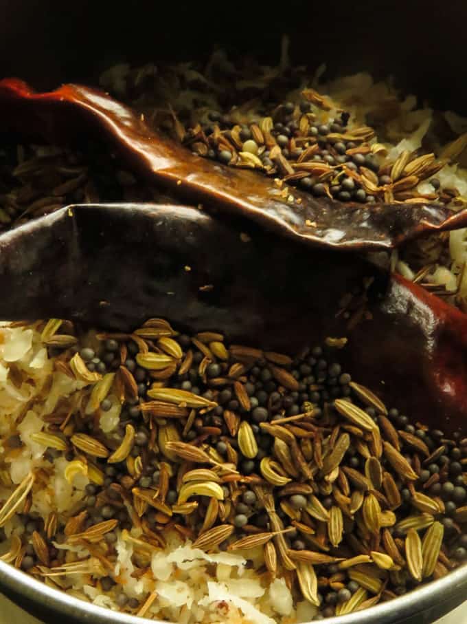 grinding all the spices and toasted raw rice and coconut flakes.