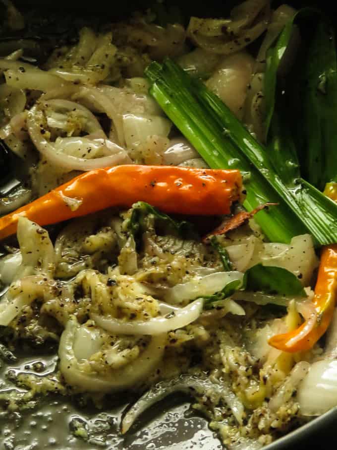 cooking the onions, curry leaves to cook the chicken curry.