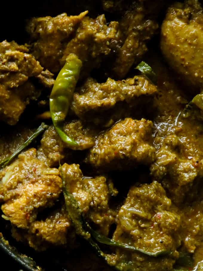 black chicken curry with green chillies and and pandan leaves.