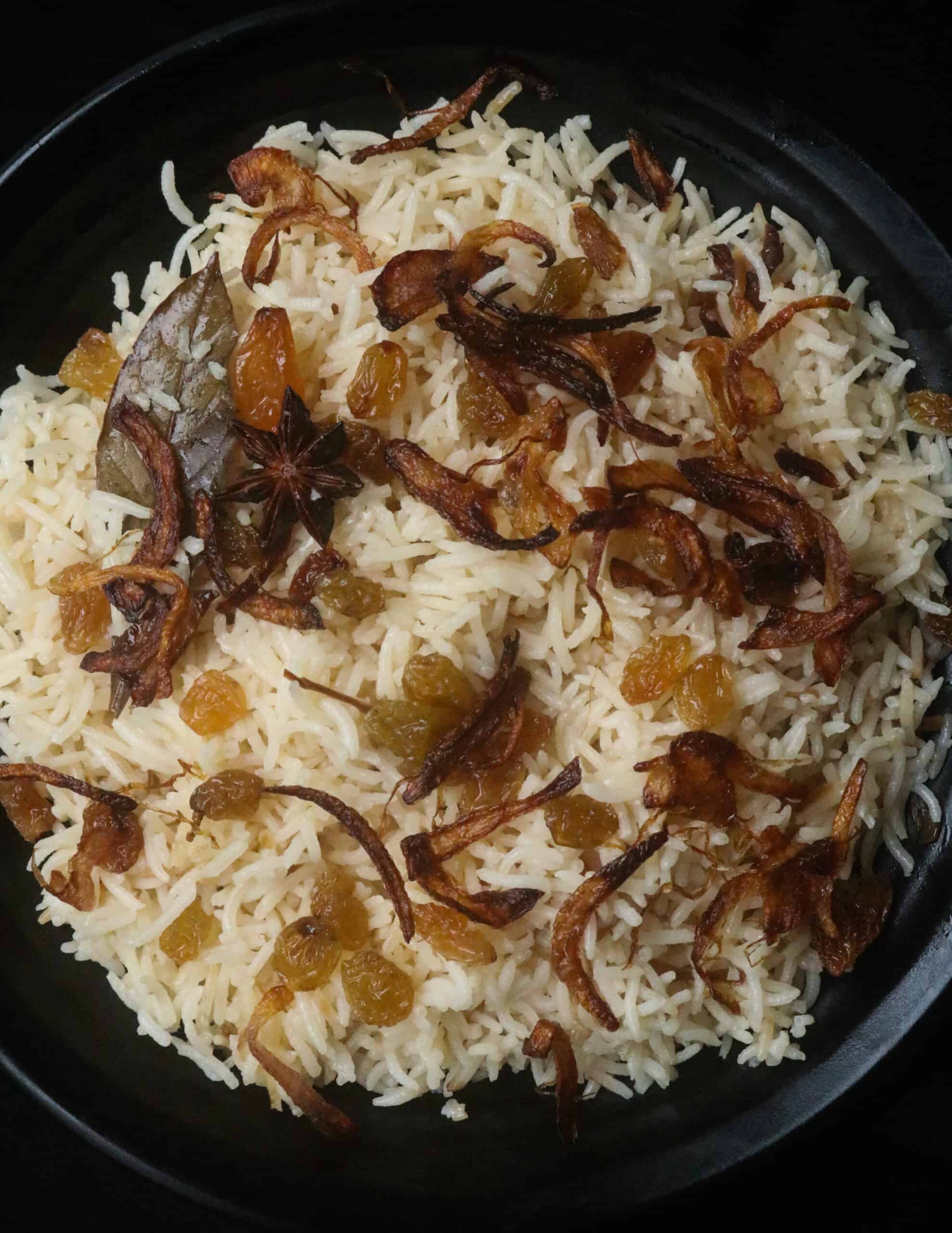 ghee rice with fried onions and raisins.