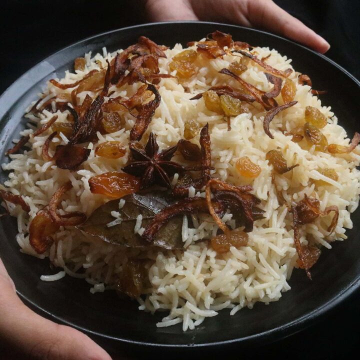 fragrant ghee rice served on a black platter.