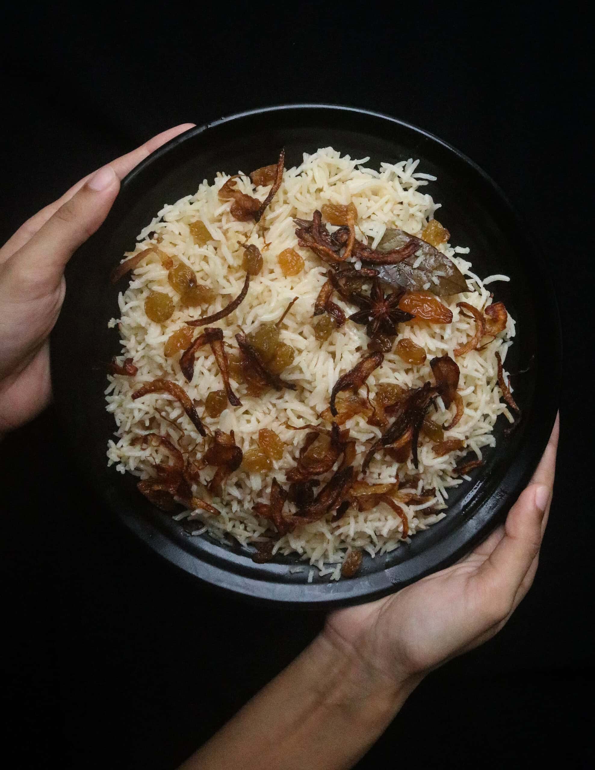 ghee rice with fried onions garnished over the rice.