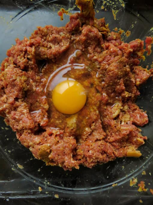 Add the egg and salt to season to the minced beef and bread mixture and mix well until combined.