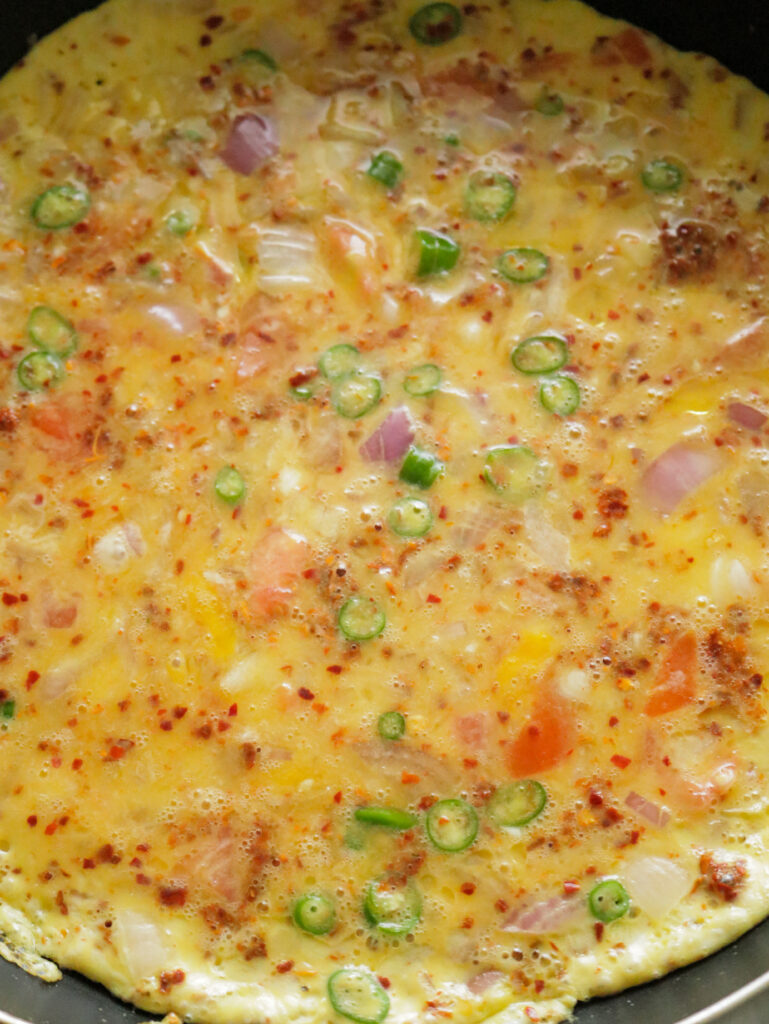 cooking omelette with onion and spices