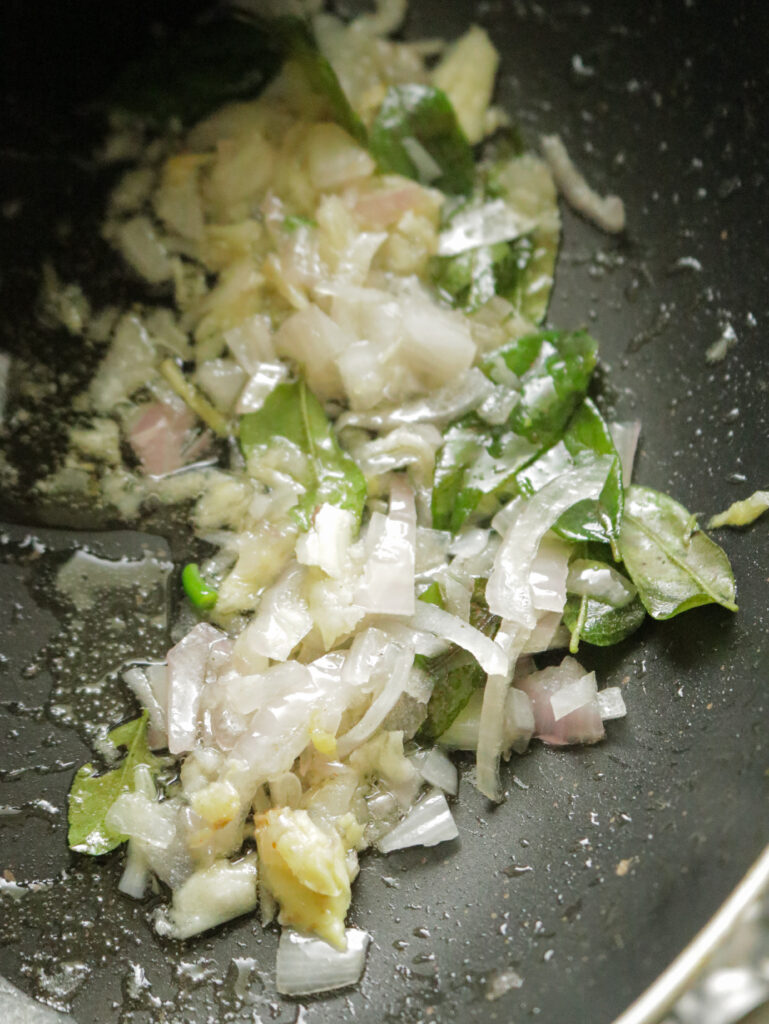 cooking onions, garlic, curry leaves in oil