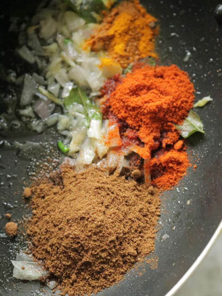 adding spices to the cooking ingredients
