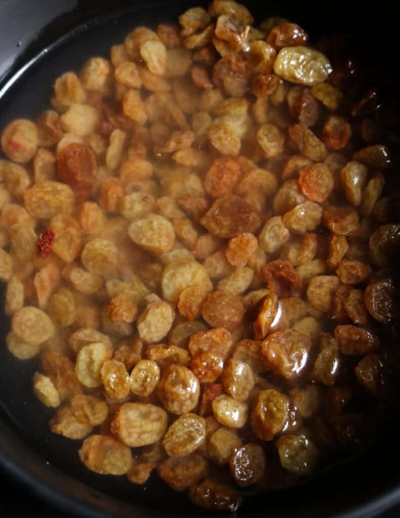 soaking the raisins to make the date and lime chutney.