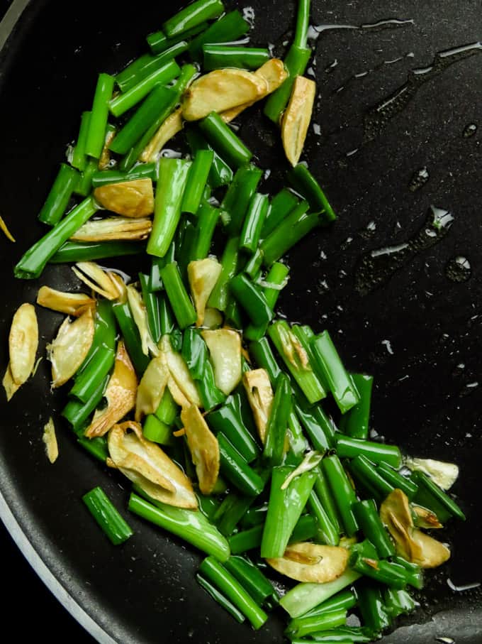 egg garlic fried rice- cooking spring onions with garlic.