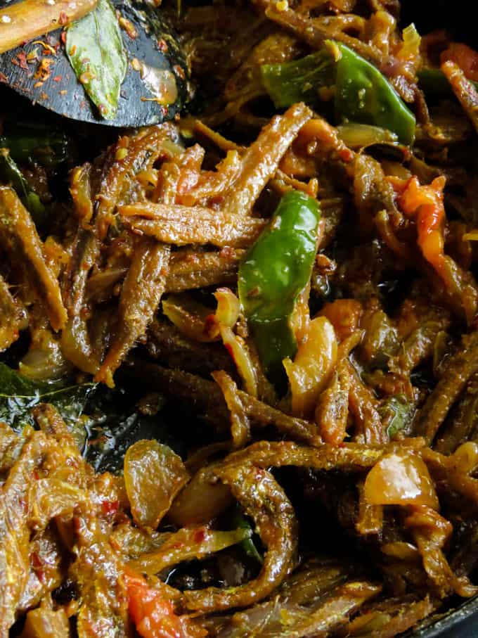 Sri Lankan dry sprats tempered in tomato and onion fry. When you think of Sri Lankan village type rice and curry, a tempered sprat fry would be the best side-dish to the menu.