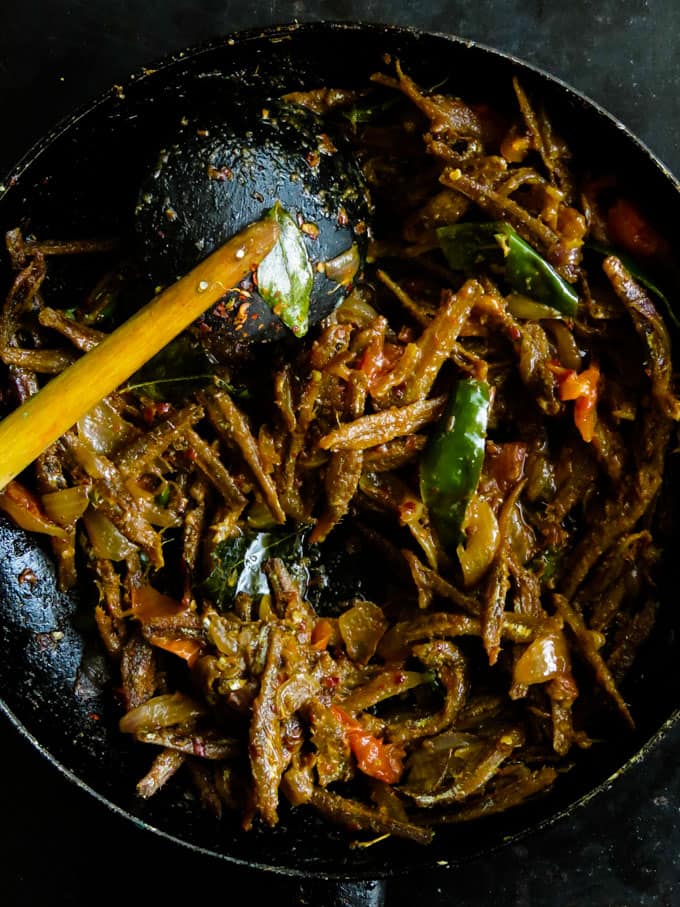 Sri Lankan dry sprats tempered in tomato and onion fry. When you think of Sri Lankan village type rice and curry, a tempered sprat fry would be the best side-dish to the menu.