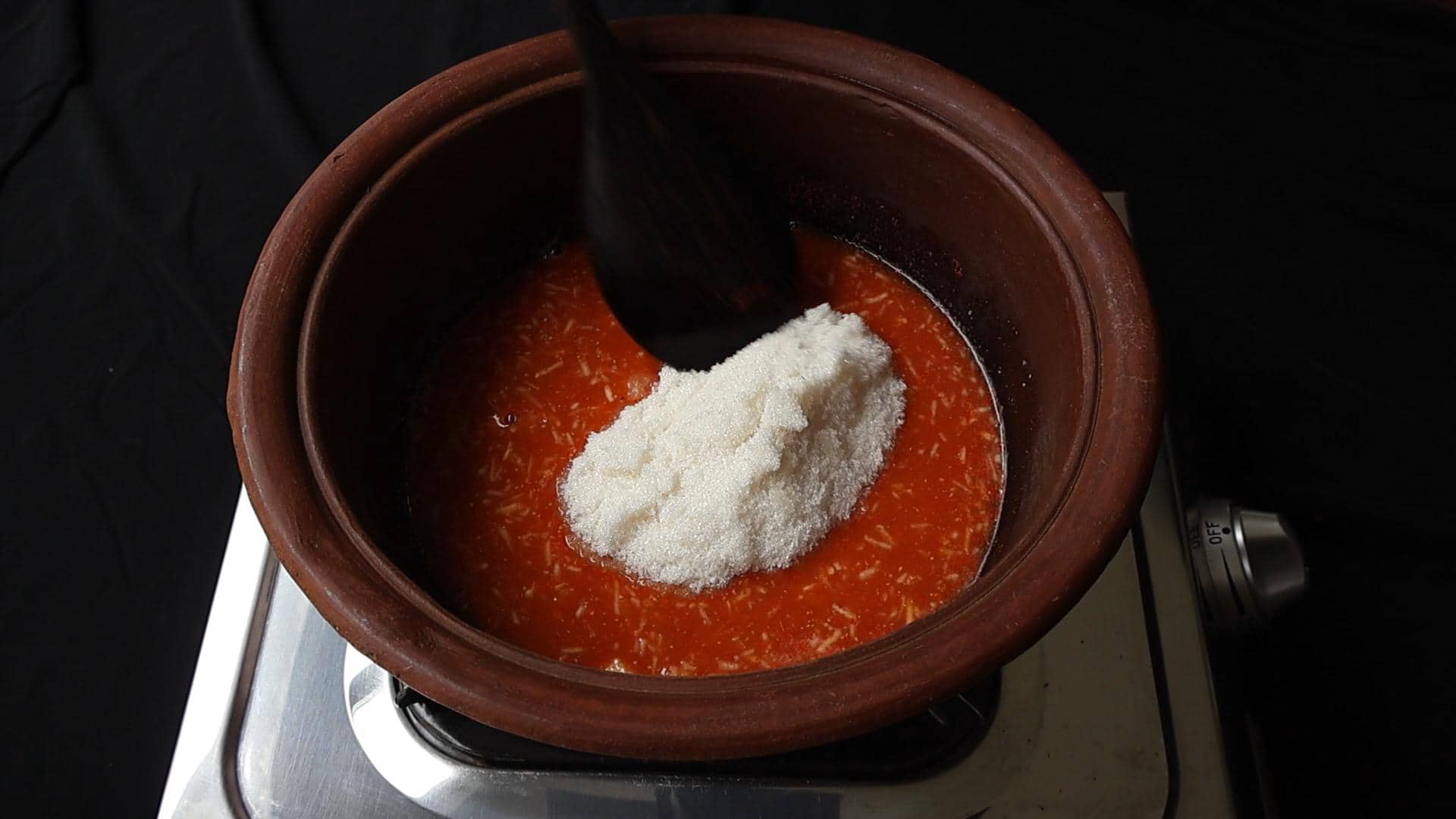 adding sugar to the date and lime chutney liquid.