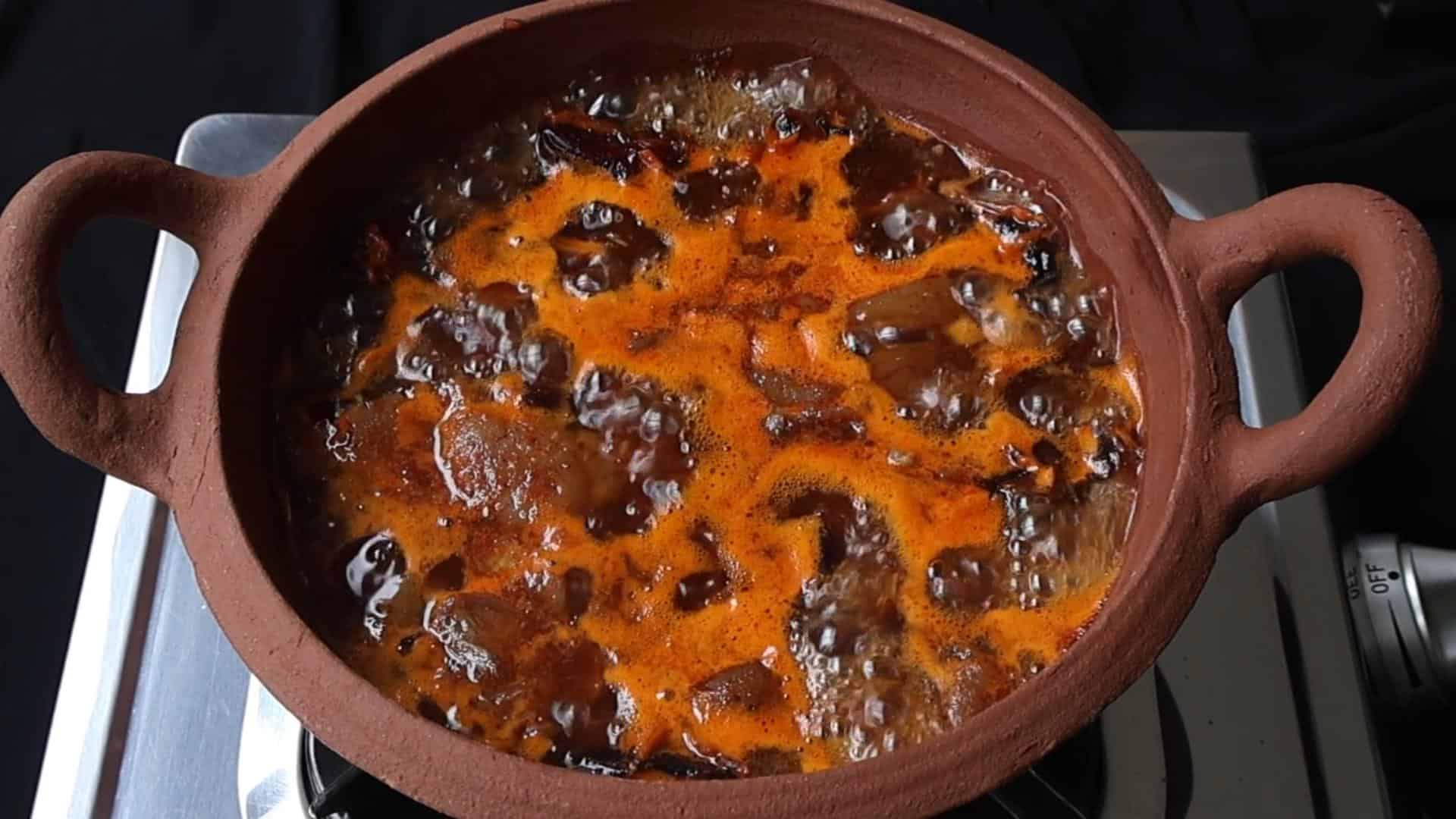 boiling the dates and lime to cook the date and lime chutney.