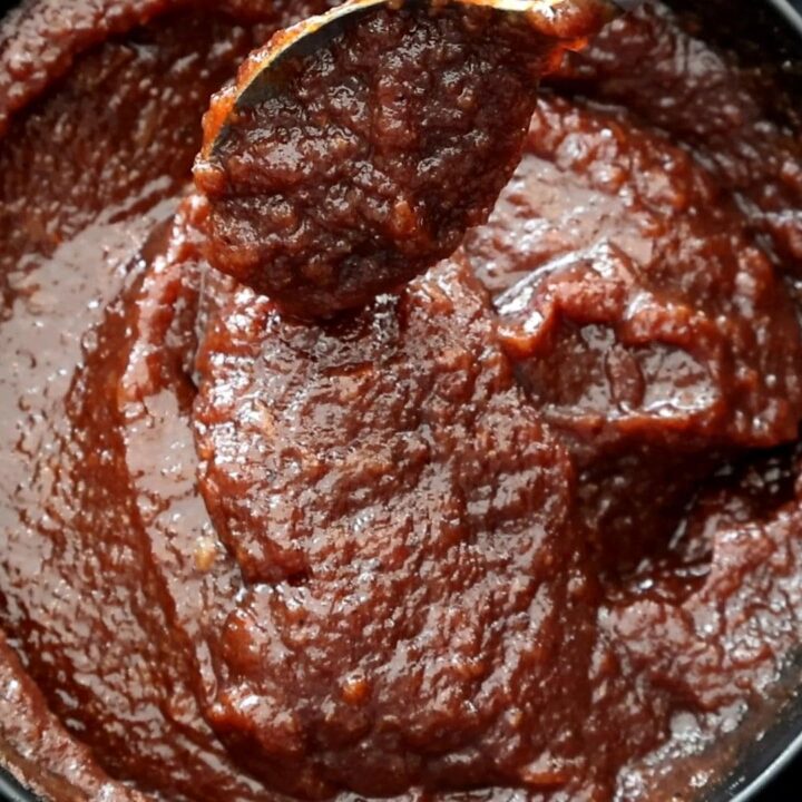 date and lime chutney served with a spoon.