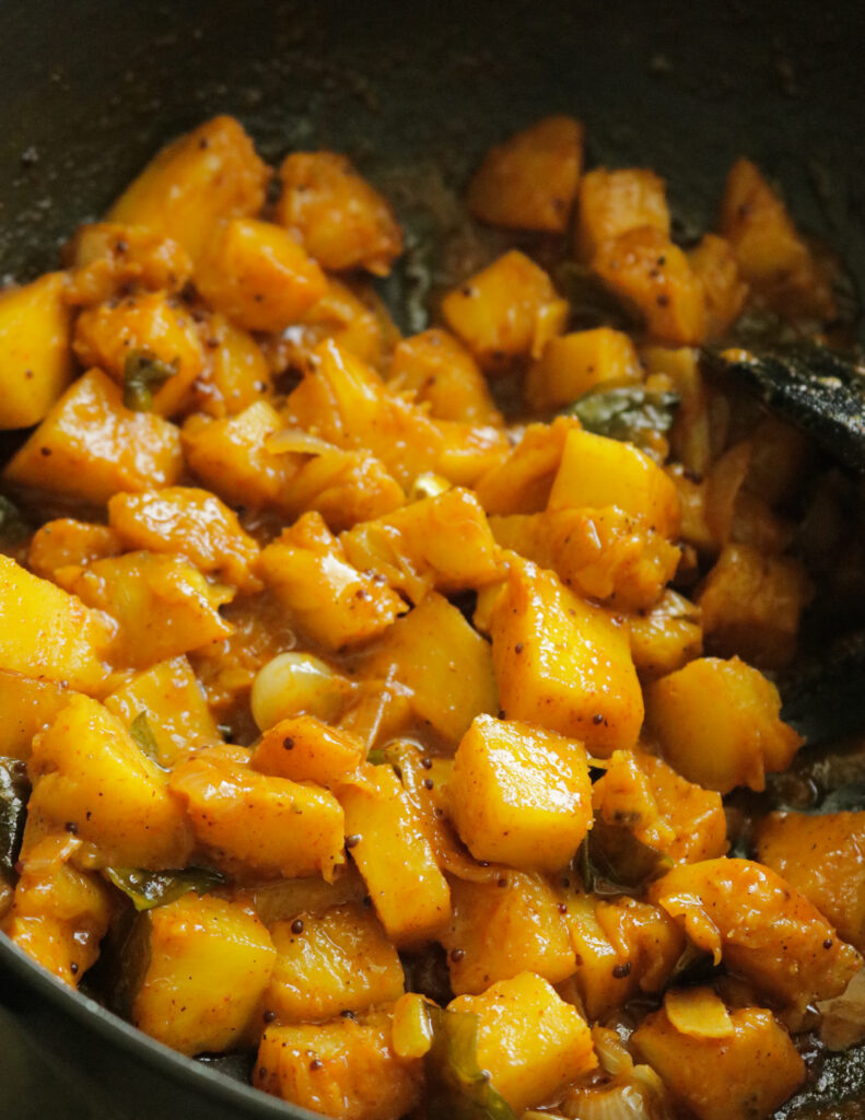 cooked pineapple cubes in a pan.