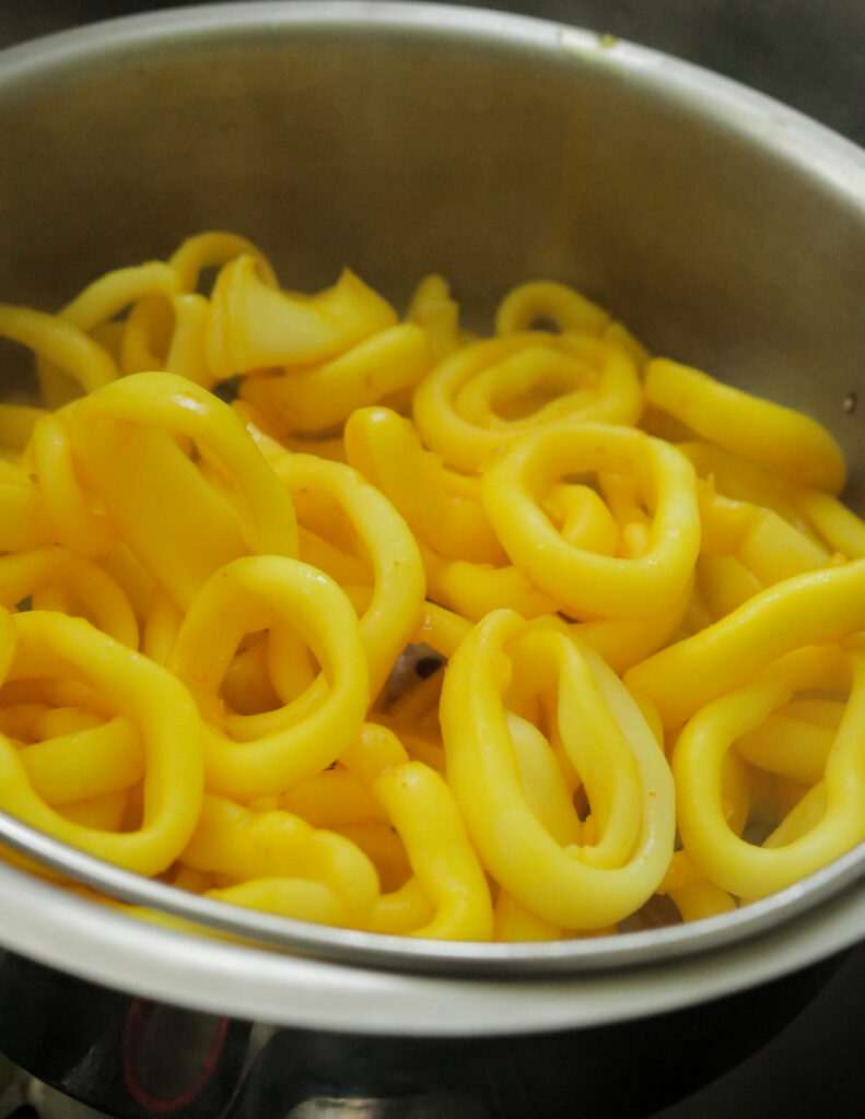 boiled calamari rings with turmeric and drained of water.