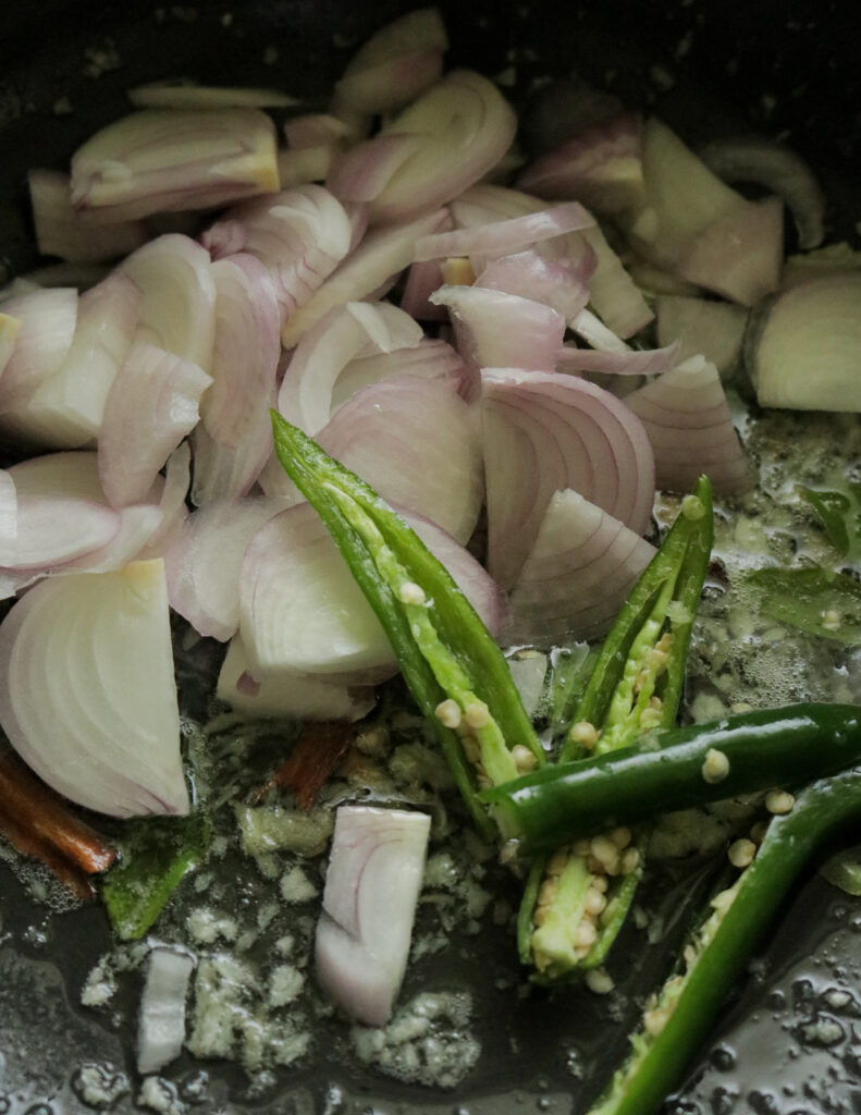 adding onions, green chilles added to the tempering minced garlic and curry leaves.