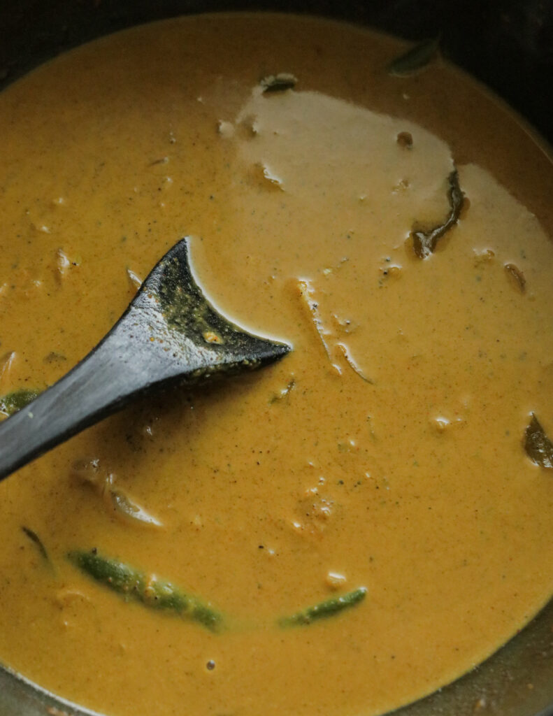 cooking the coconut milk gravy for the calamari curry.