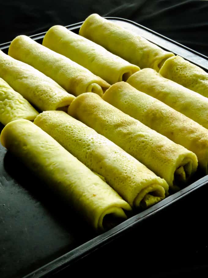 coconut milk pancakes with jaggery filling also known as pol pani.  Here's your step-by-step guide on how to make a classic Sri Lankan sweet snack. All you need are a few thin pancakes/crepes and a filling made with scraped coconut and jaggery(palm sugar).