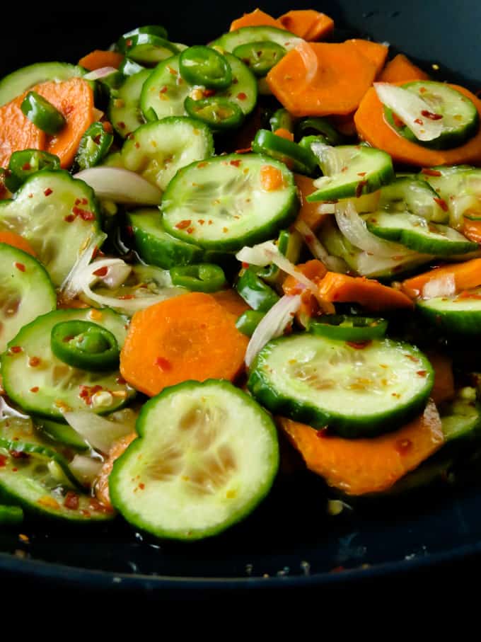 quick pickled cucumber and carrot relish. A spicy, sweet and sour cucumber salad to serve with all your grilled meats or just to munch on.