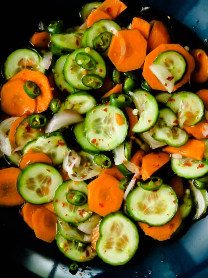 quick pickled cucumber and carrot relish. A spicy, sweet and sour cucumber salad to serve with all your grilled meats or just to munch on.