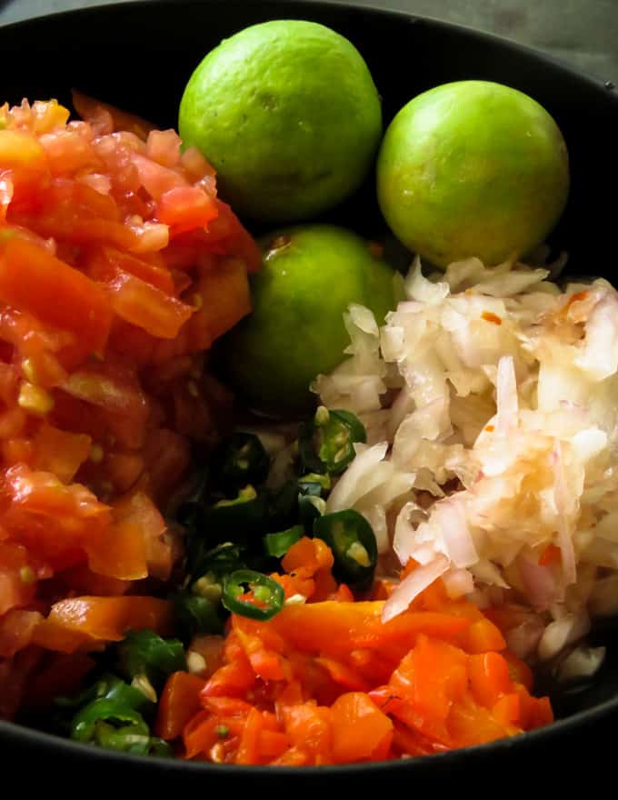 All the ingredients you need to make a spicy chunky tomato onions salsa.