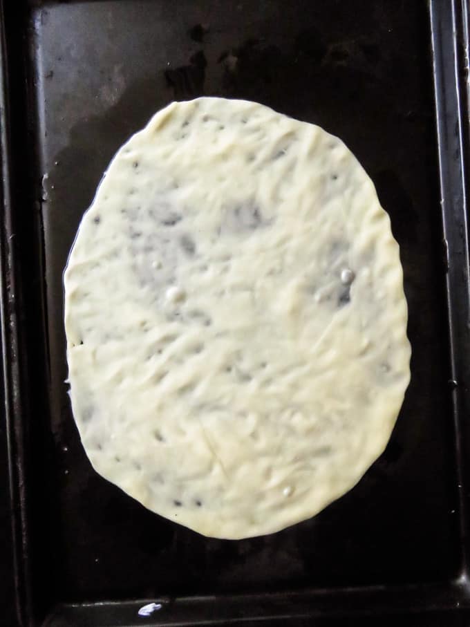 stretching the roti paratha dough thin image