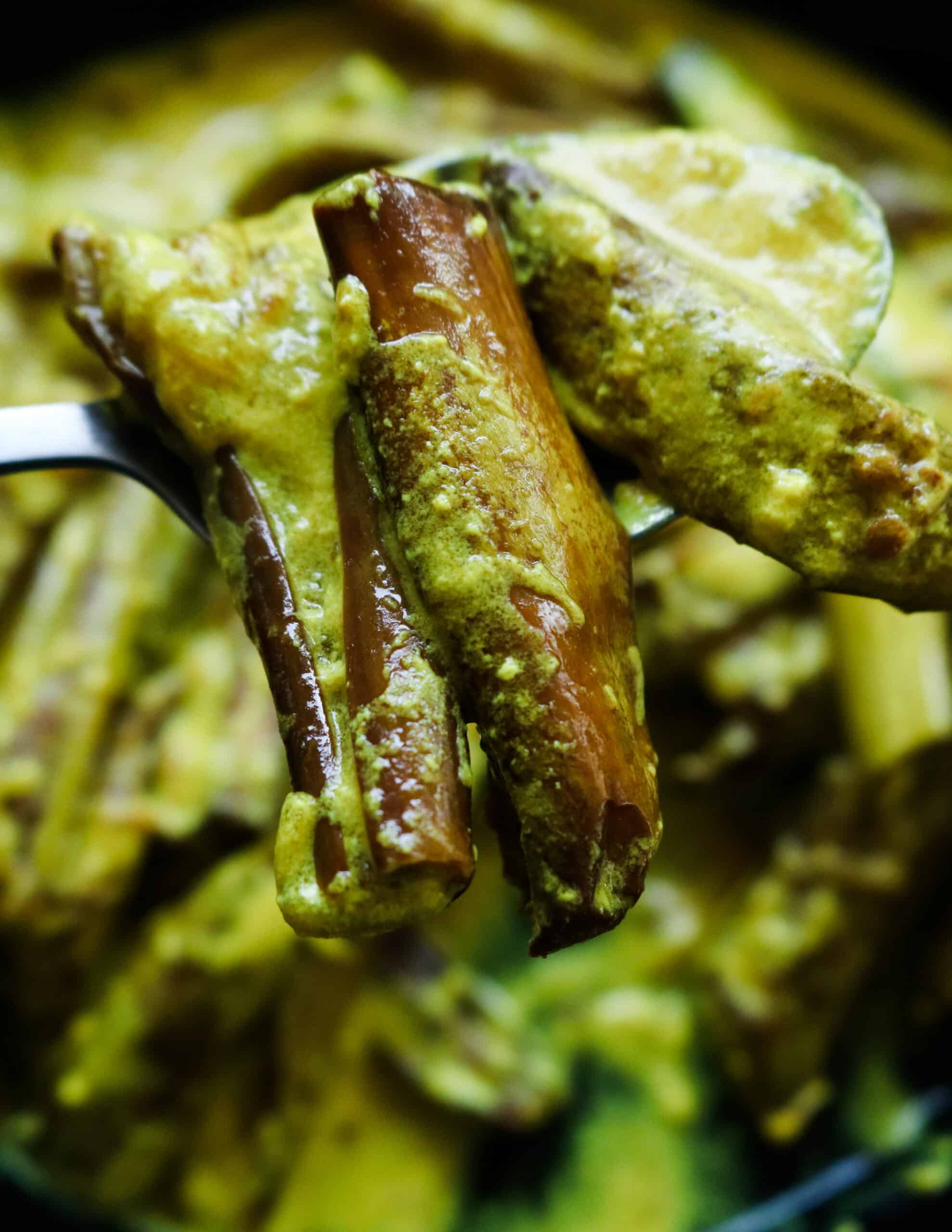 eggplant curry scooped onto a spoon