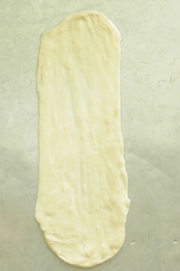 A roughly stretched vegetable roti dough.