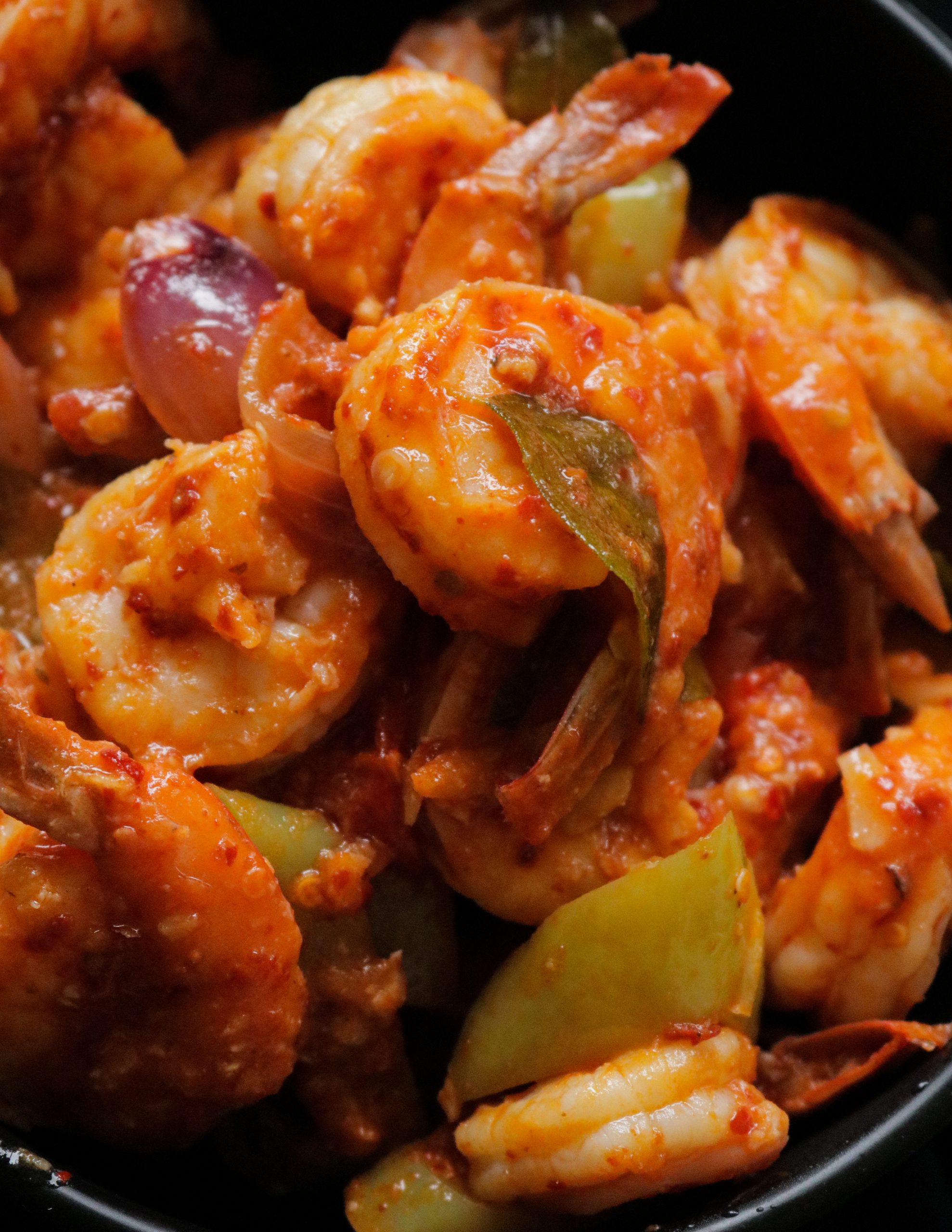 Devilled prawns served on a black bowl