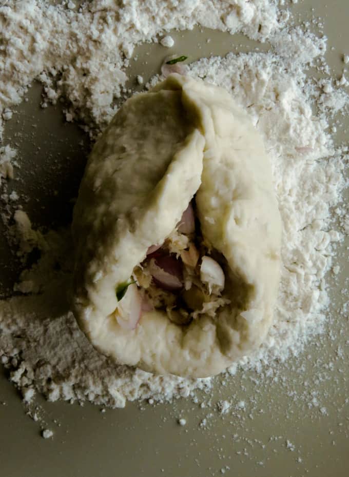 Covered roti dough with the tuna filling.