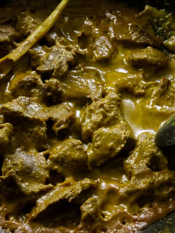 slow cooking the beef curry in lemon grass-coconut milk gravy.