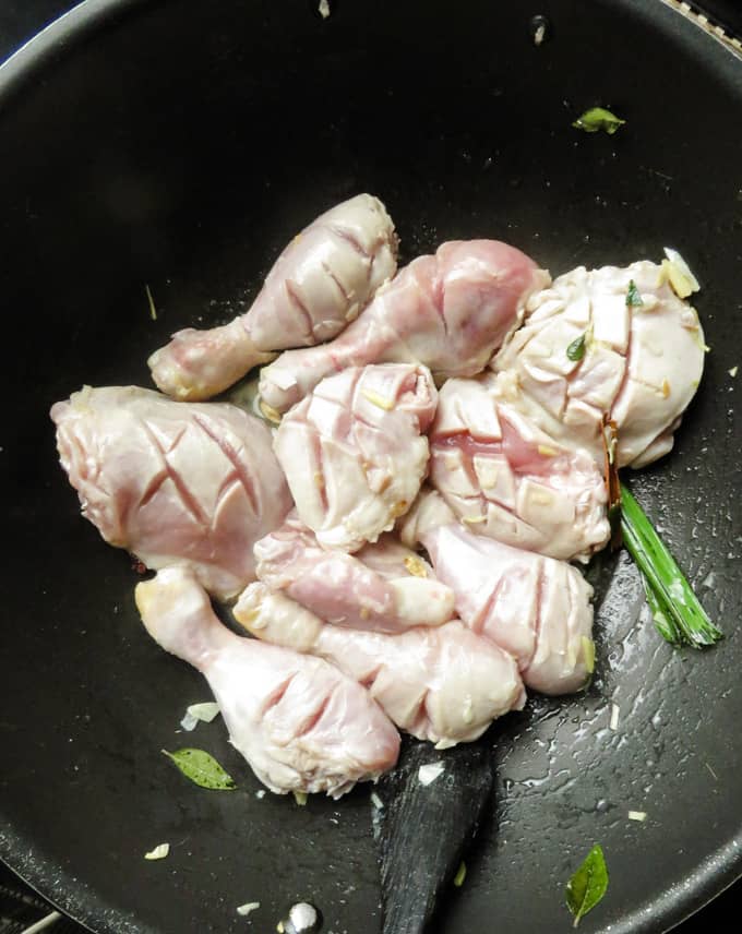 cooking the vinegar chicken in spices.