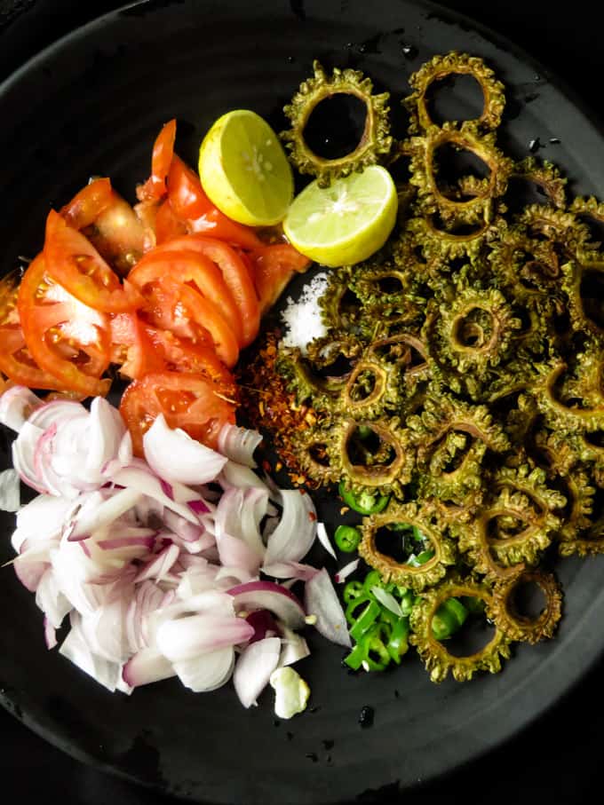 mixing all the ingredients to make the bitter gourd fry.