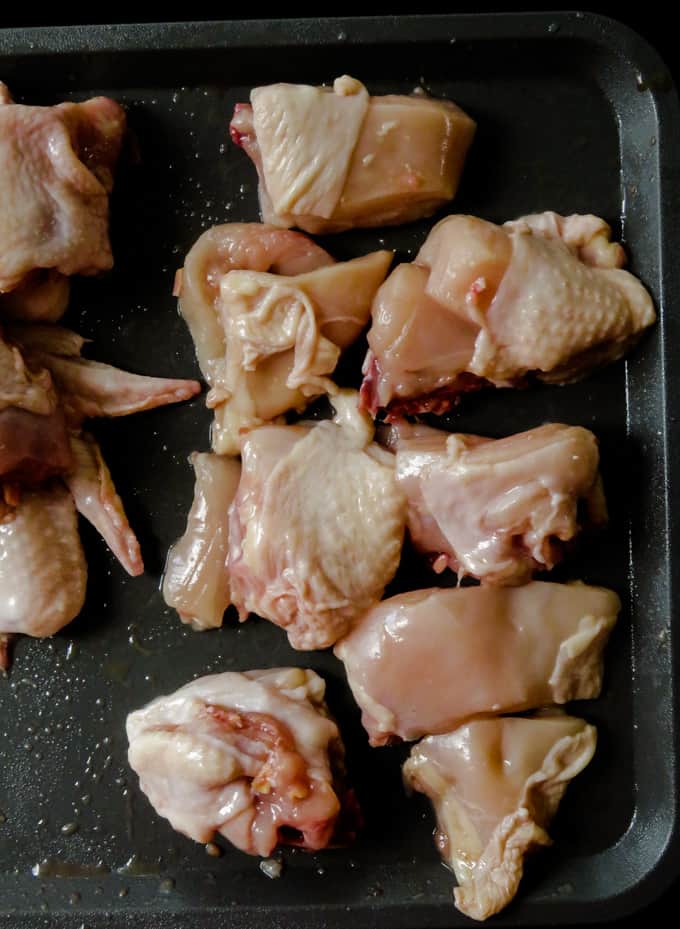 peeling the chicken skins from the chicken parts.