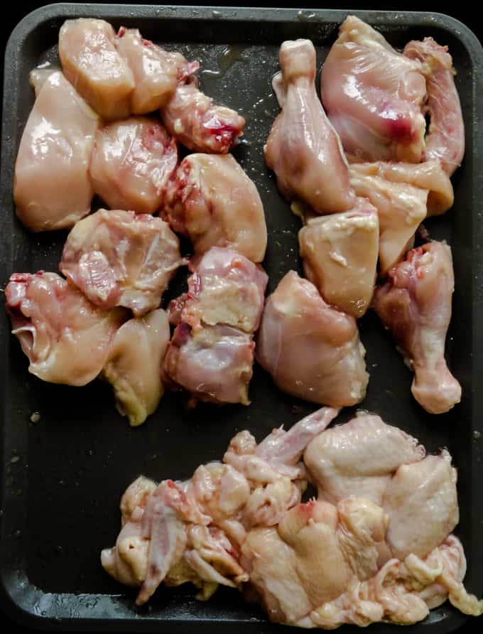 cutting the chicken into smaller parts for curries.