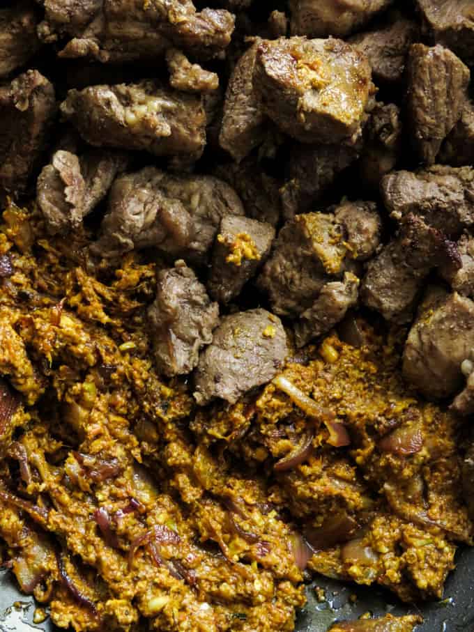 adding beef to the korma paste.