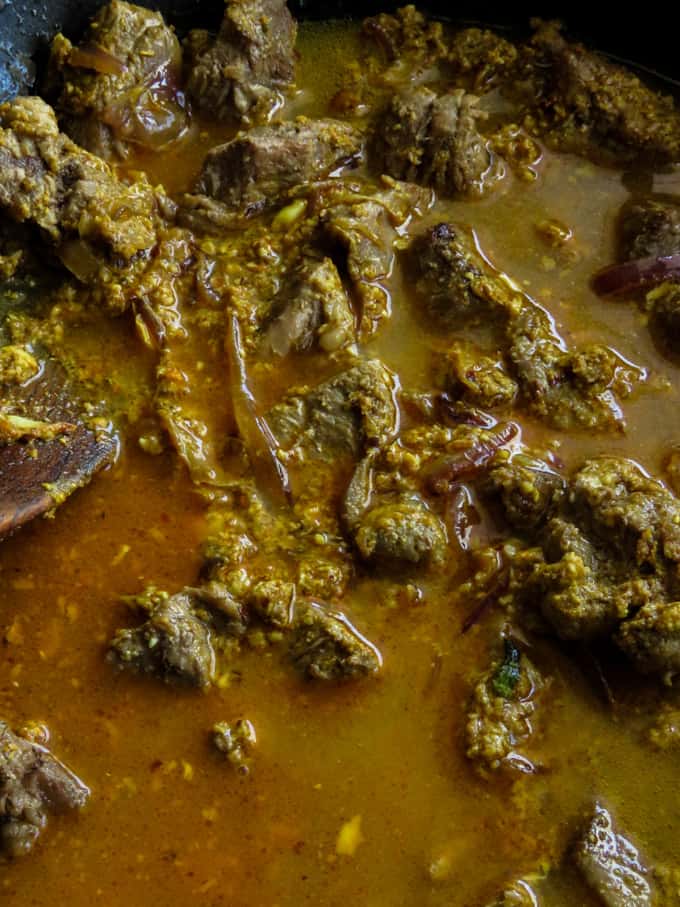 cooking the beef korma with water.