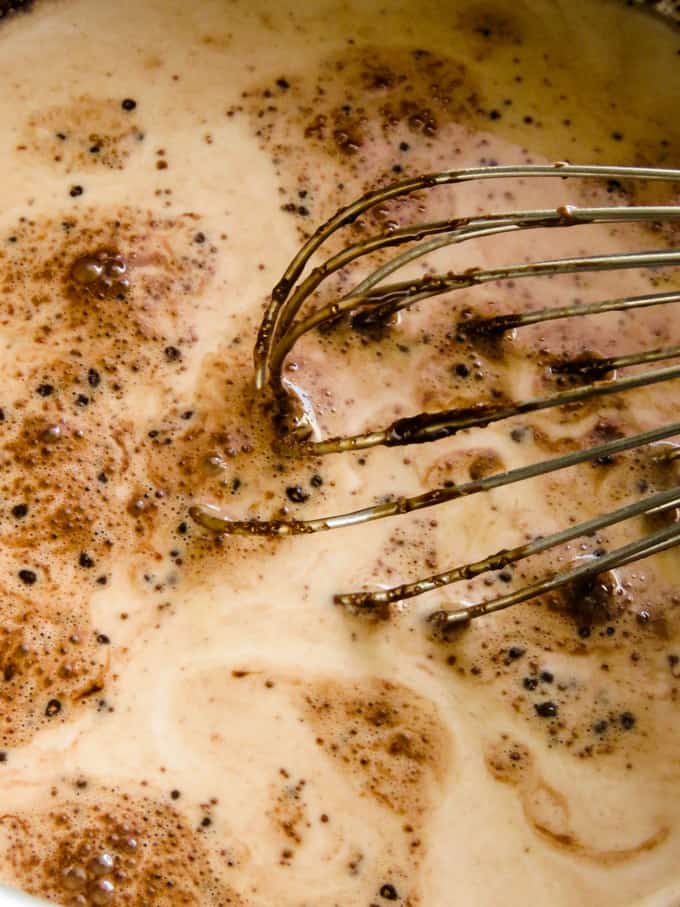 adding milk to the chocolate pudding.