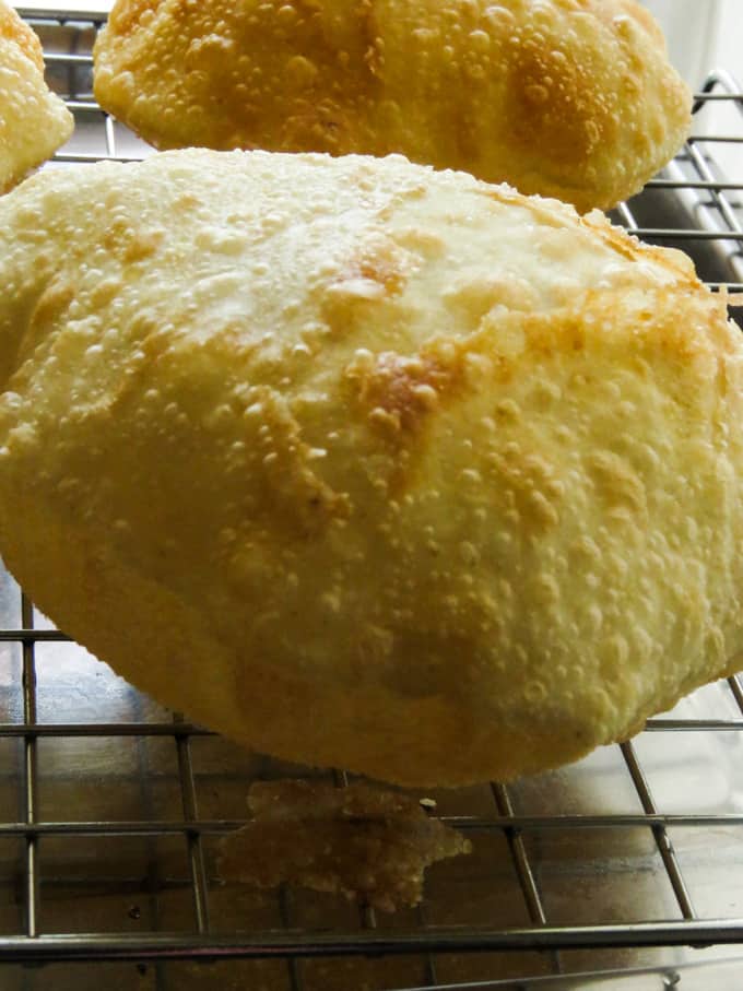 Golden Yellow Crispy Poori/Puri puffs ready to be eaten.