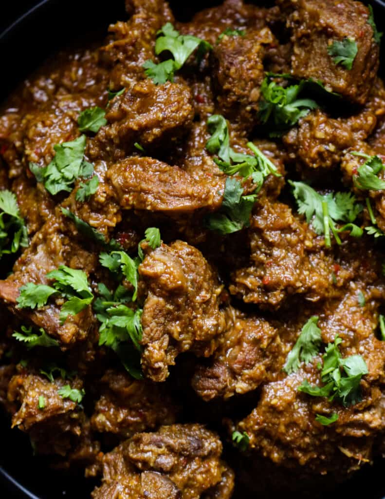 beef korma curry placed in a bowl with coriander leaf as garnish.