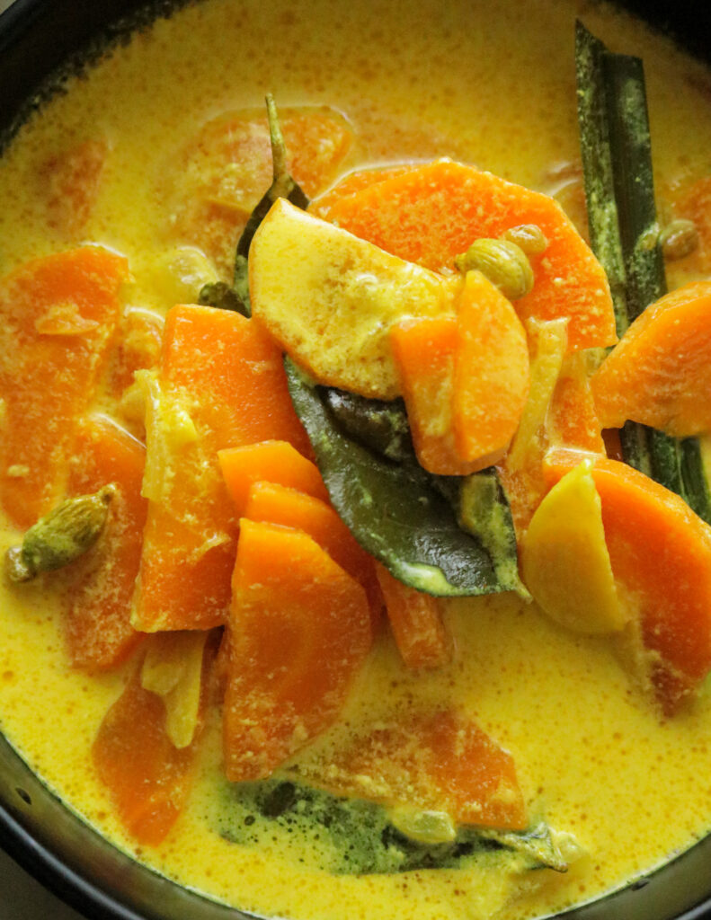 sliced carrot cooked in coconut milk and curry leaves garnished on top