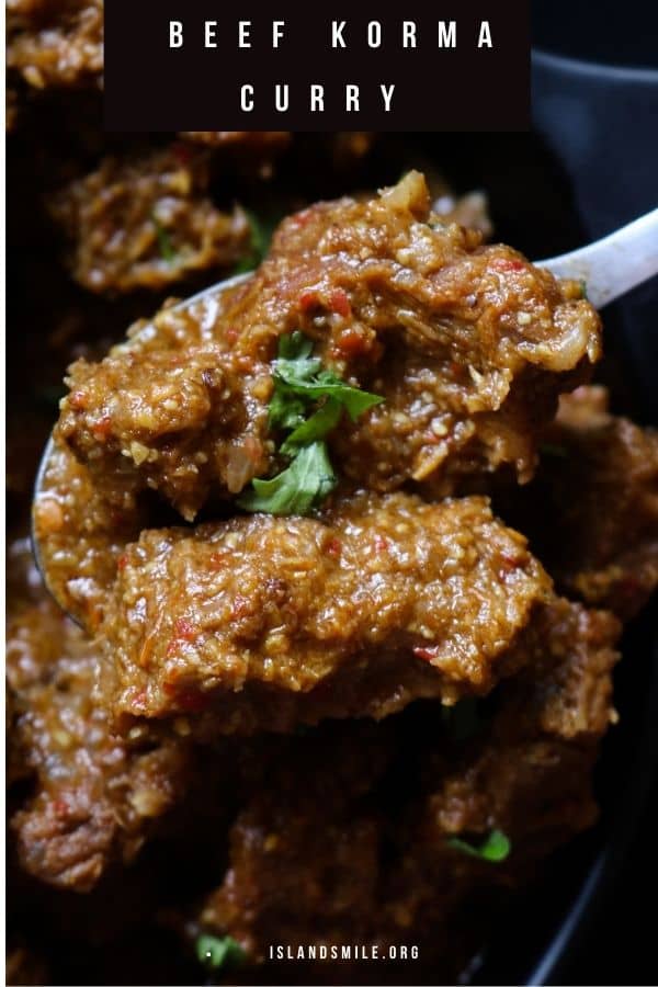 beef korma curry scooped into a spoon.