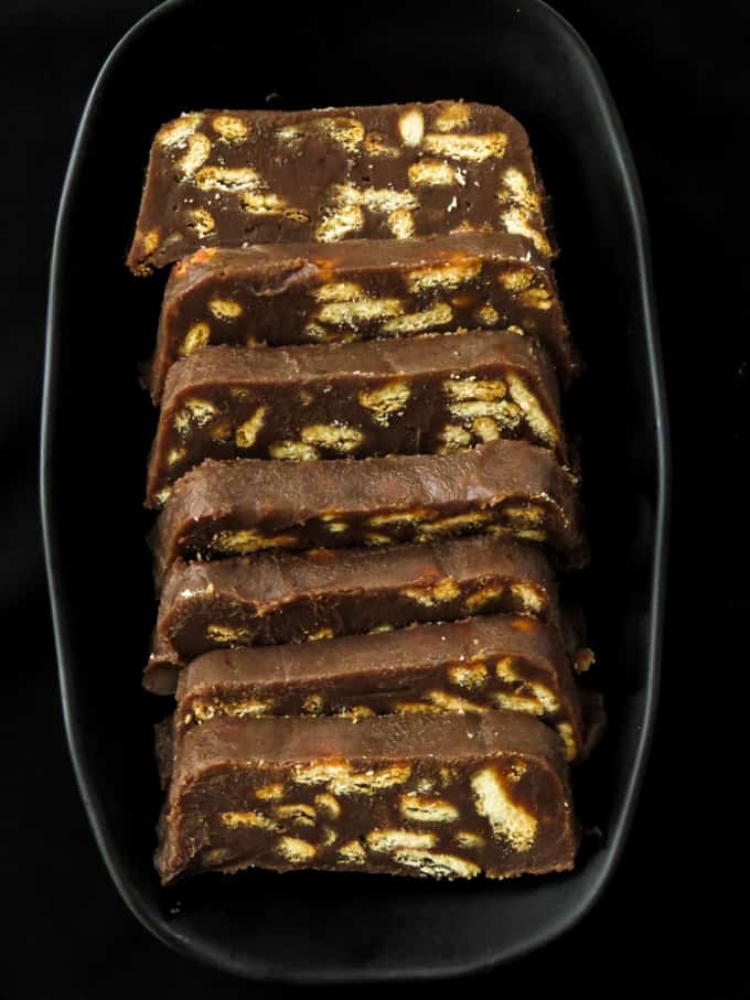 slices of chocolate biscuit cake placed in a black plate